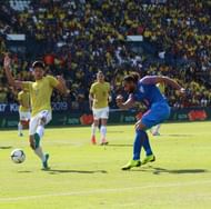 Adil (R) crosses the ball before the goal